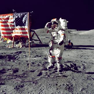 astronaut standing on moon beside U.S.A. flag by NASA courtesy of Unsplash.